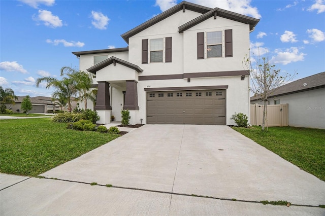 view of front of home featuring an attached garage, fence, concrete driveway, stucco siding, and a front yard