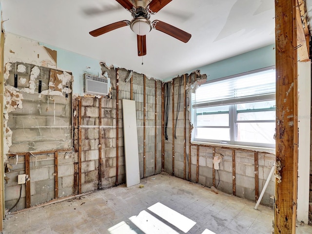 interior space with a ceiling fan and a wall mounted air conditioner