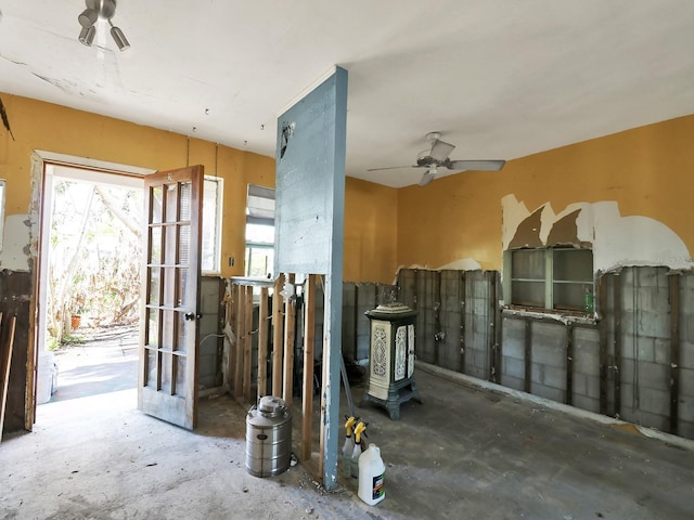 interior space with unfinished concrete flooring and a ceiling fan