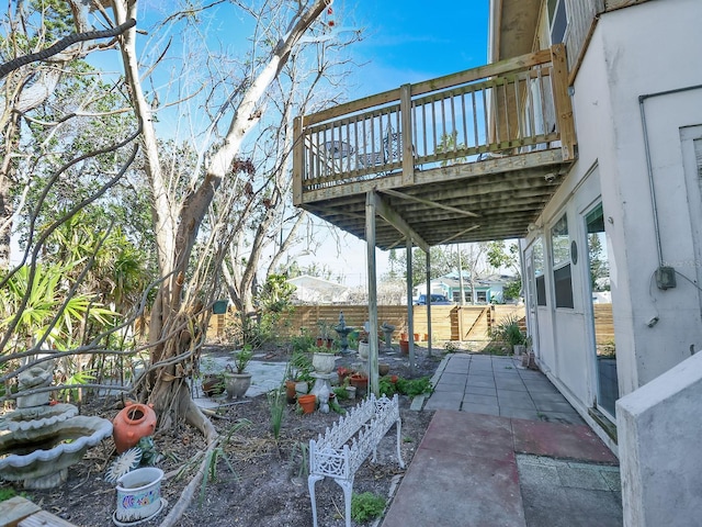 exterior space featuring a patio, a deck, and fence