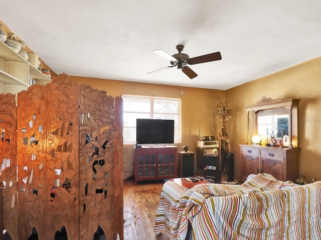 living area with hardwood / wood-style flooring and a ceiling fan