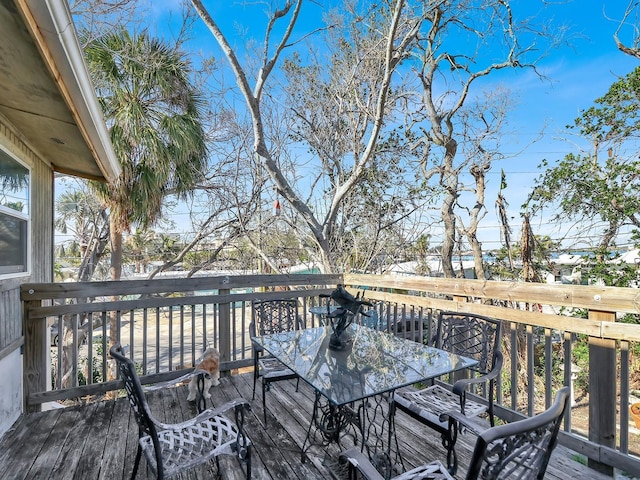 wooden terrace featuring outdoor dining area