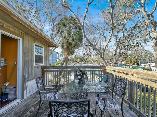 wooden terrace featuring outdoor dining area