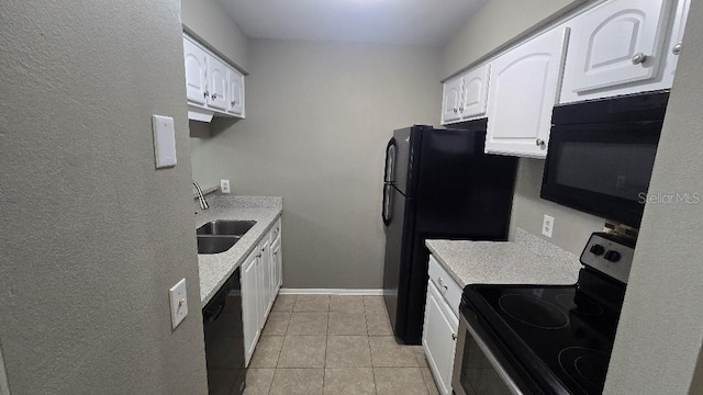 kitchen with black appliances, white cabinets, a sink, and light countertops