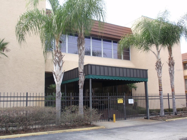 view of property with fence