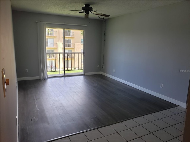 empty room featuring a ceiling fan, baseboards, a textured ceiling, and wood finished floors