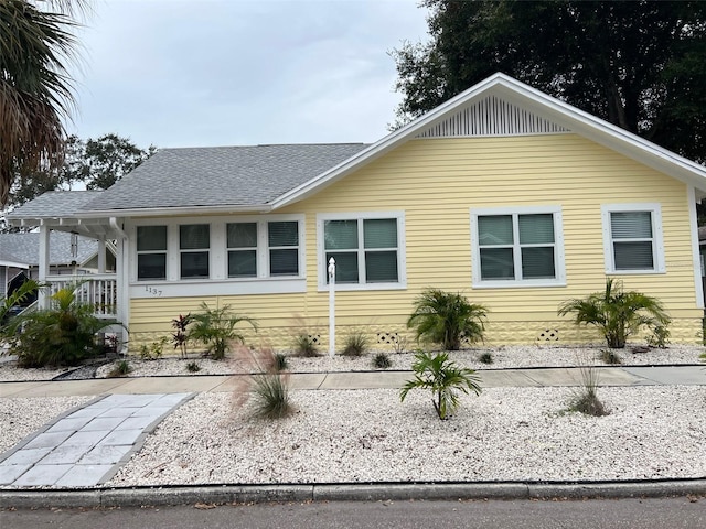 exterior space featuring roof with shingles