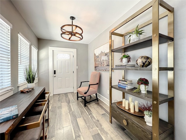 entryway featuring baseboards and light wood finished floors