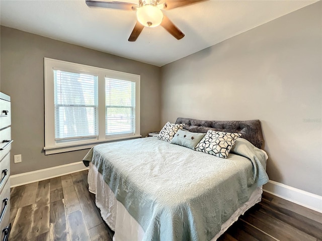 bedroom with dark wood-style floors, baseboards, and a ceiling fan