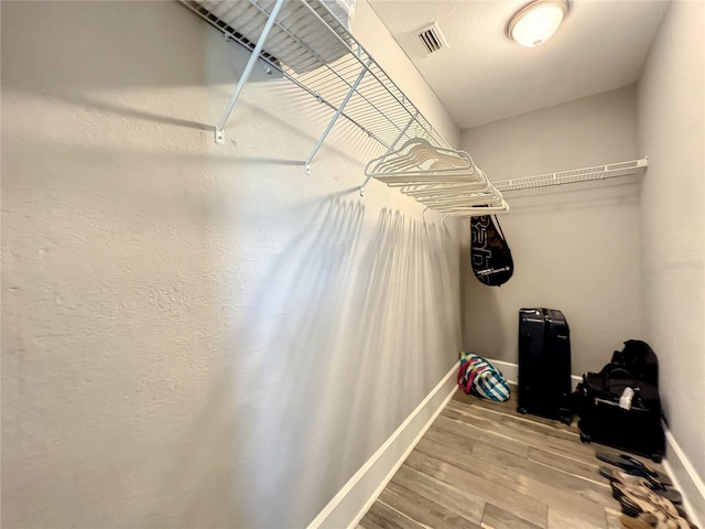 spacious closet with visible vents and wood finished floors