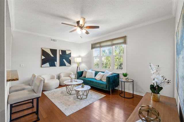 living room featuring visible vents, crown molding, and hardwood / wood-style floors