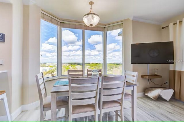 dining space with wood finished floors and baseboards