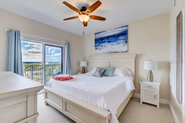 bedroom with access to exterior, light colored carpet, ceiling fan, and baseboards