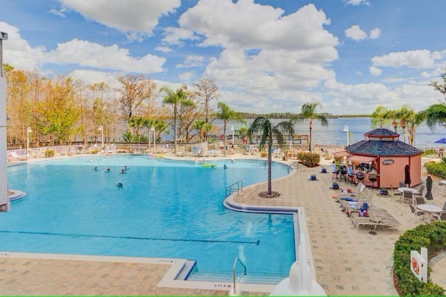 community pool featuring a water view and a patio area