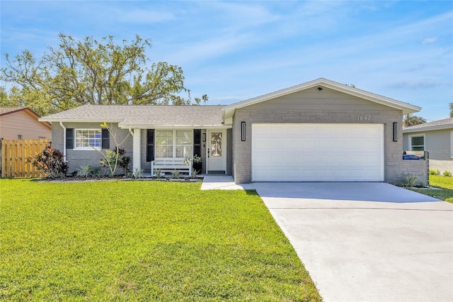 1842 Oklahoma Ave NE, Saint Petersburg, FL 33703 - single story home featuring a front lawn, concrete driveway, an attached garage, and fence