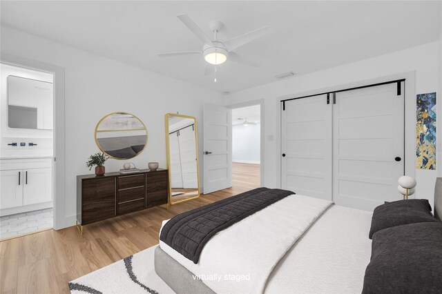 1842 Oklahoma Ave NE, Saint Petersburg, FL 33703 - bedroom featuring visible vents, ensuite bath, a closet, light wood-style floors, and ceiling fan