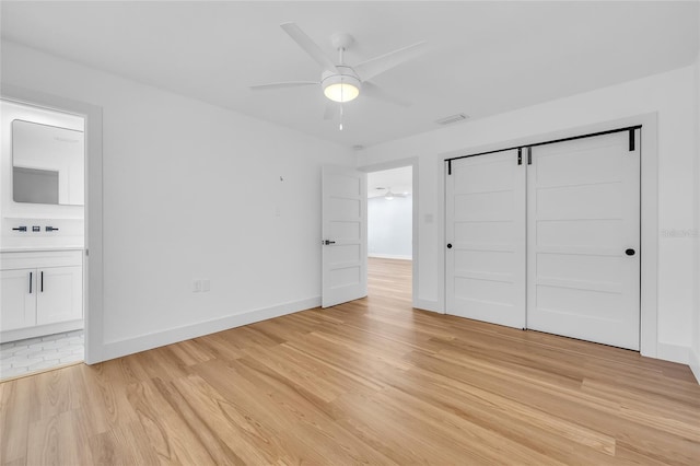 1842 Oklahoma Ave NE, Saint Petersburg, FL 33703 - unfurnished bedroom featuring light wood-type flooring, visible vents, ensuite bathroom, a closet, and baseboards