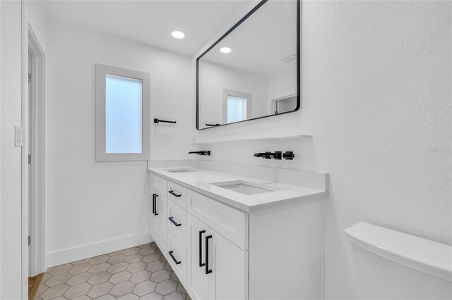 1842 Oklahoma Ave NE, Saint Petersburg, FL 33703 - full bath with double vanity, toilet, baseboards, and a sink
