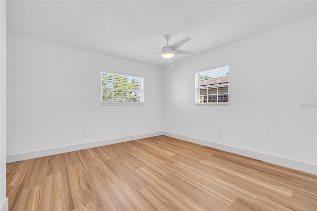 1842 Oklahoma Ave NE, Saint Petersburg, FL 33703 - unfurnished room featuring a wealth of natural light, a ceiling fan, light wood-type flooring, and baseboards