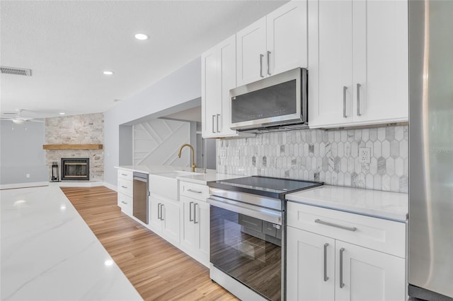 1842 Oklahoma Ave NE, Saint Petersburg, FL 33703 - kitchen with a sink, stainless steel appliances, tasteful backsplash, and visible vents