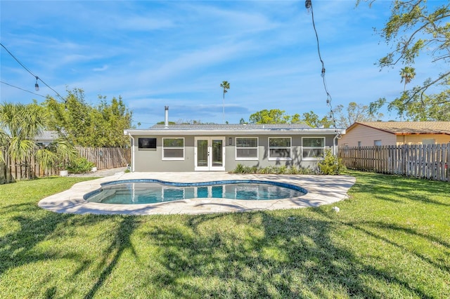 1842 Oklahoma Ave NE, Saint Petersburg, FL 33703 - back of property featuring stucco siding, a fenced backyard, french doors, a yard, and a fenced in pool