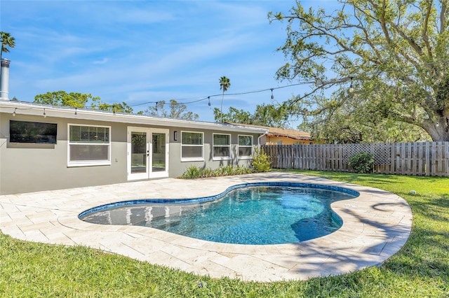 1842 Oklahoma Ave NE, Saint Petersburg, FL 33703 - view of swimming pool featuring a fenced in pool, a lawn, french doors, a fenced backyard, and a patio area
