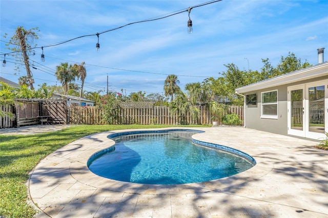 1842 Oklahoma Ave NE, Saint Petersburg, FL 33703 - view of swimming pool with a fenced in pool, a lawn, french doors, a fenced backyard, and a patio area