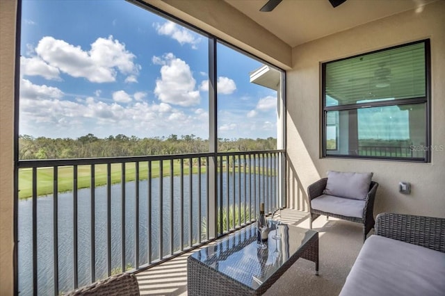 sunroom featuring a water view and ceiling fan