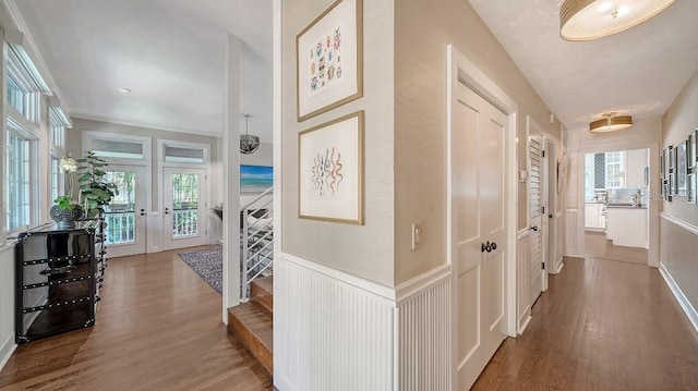 hall featuring wainscoting and wood finished floors