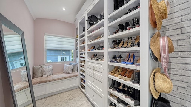 walk in closet featuring marble finish floor