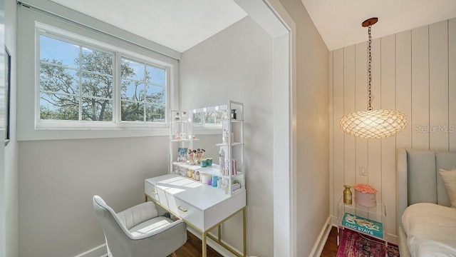 interior space featuring baseboards and wood finished floors