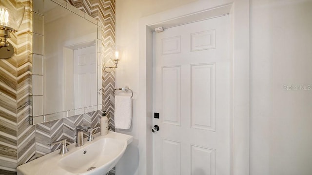 bathroom with a sink and backsplash