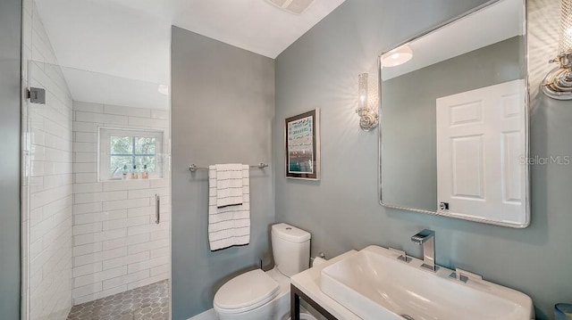 bathroom featuring toilet, a shower stall, visible vents, and a sink