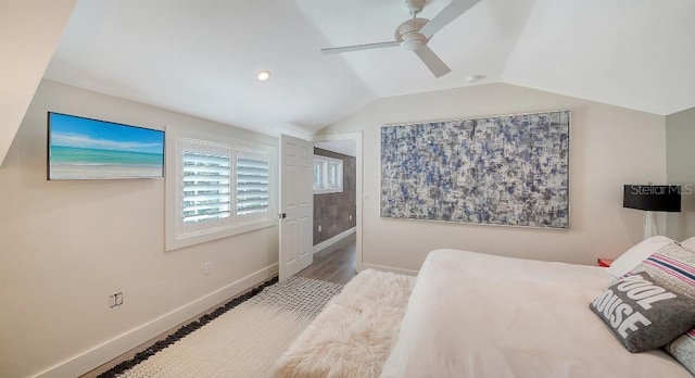 bedroom with lofted ceiling, a ceiling fan, baseboards, and wood finished floors