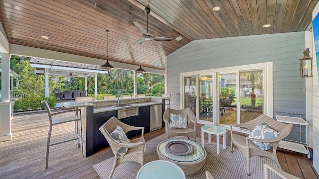 wooden deck featuring a ceiling fan and area for grilling