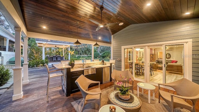 wooden deck with a ceiling fan, outdoor dining space, and a sink