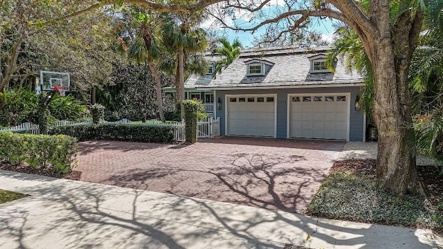 garage with driveway and fence