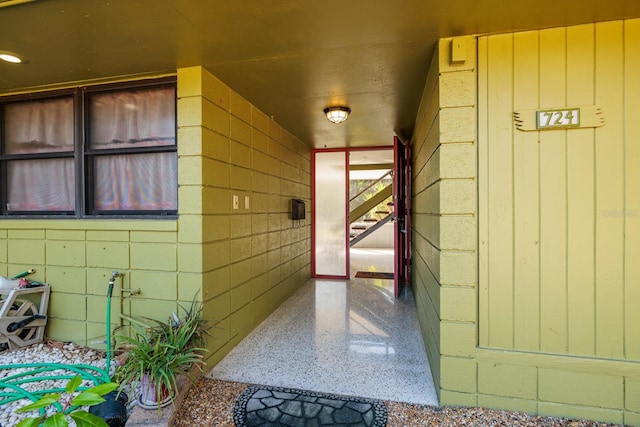 property entrance featuring concrete block siding