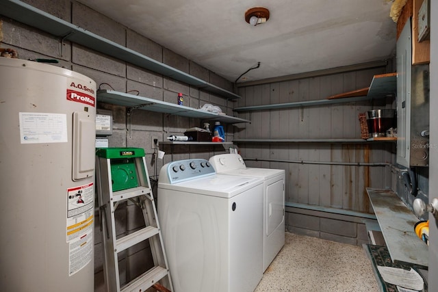 laundry room featuring washer and dryer, electric water heater, and laundry area