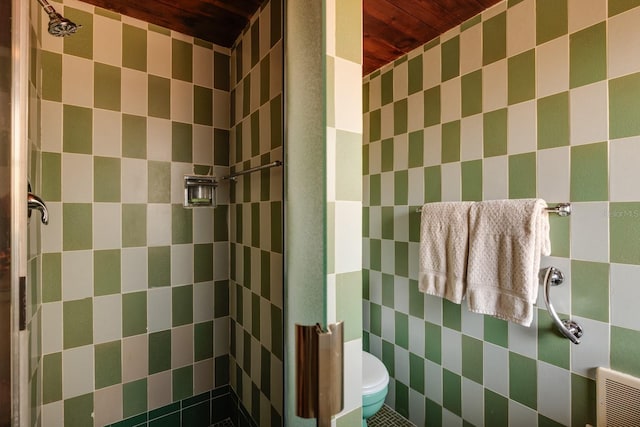 bathroom featuring a shower stall, wooden ceiling, and toilet