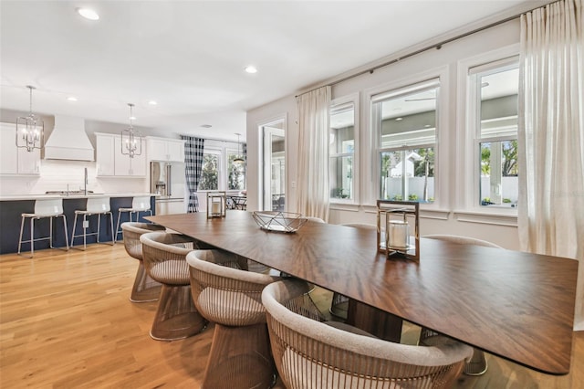 4012 W Morrison Ave, Tampa, FL 33629 - dining space featuring light wood-style flooring, a notable chandelier, recessed lighting, and a wealth of natural light