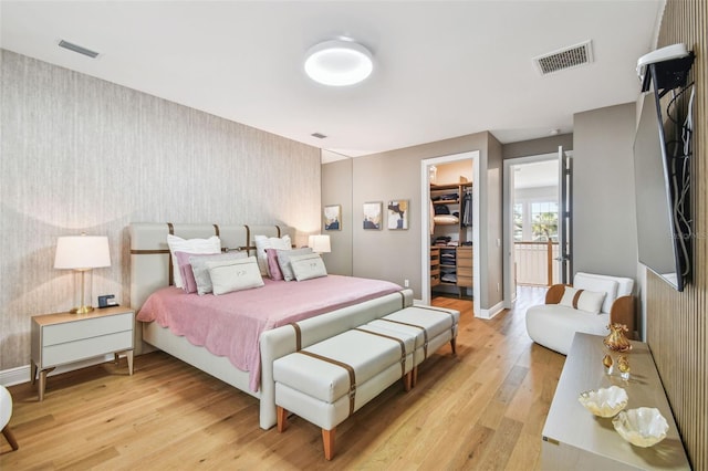 4012 W Morrison Ave, Tampa, FL 33629 - bedroom with visible vents, light wood finished floors, a spacious closet, and wallpapered walls