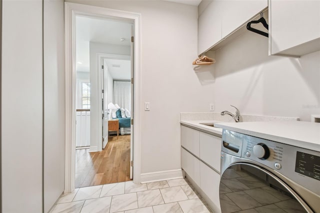 4012 W Morrison Ave, Tampa, FL 33629 - washroom featuring washer / clothes dryer, cabinet space, baseboards, and a sink