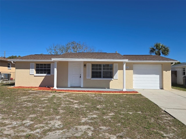 ranch-style house with stucco siding, concrete driveway, an attached garage, a front yard, and central AC