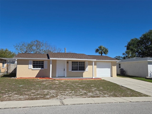 ranch-style house with a garage, concrete driveway, fence, and stucco siding