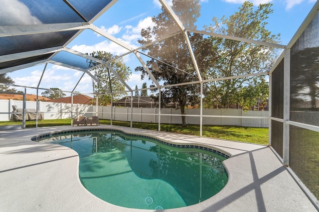 view of swimming pool with a fenced in pool, glass enclosure, a patio area, and a fenced backyard