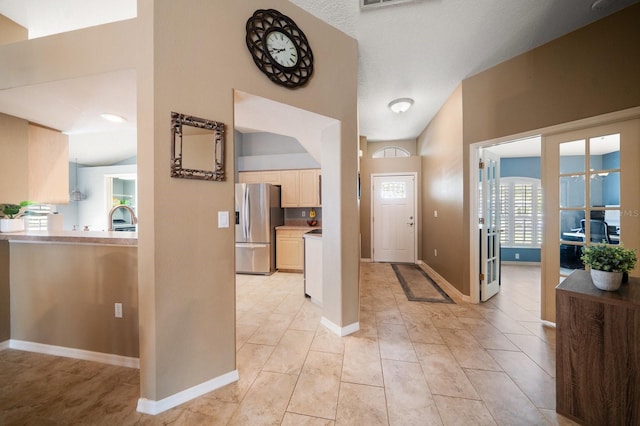 foyer entrance with visible vents and baseboards