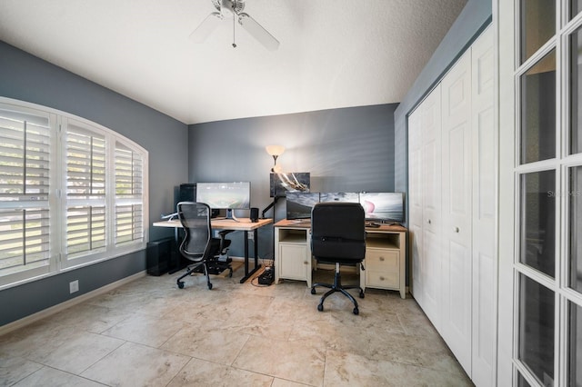 office area featuring ceiling fan and baseboards