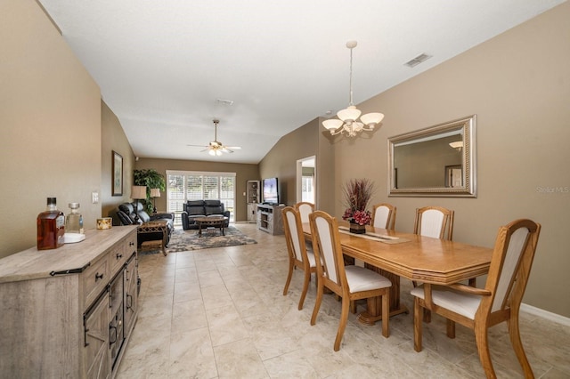 dining space with lofted ceiling, visible vents, and ceiling fan with notable chandelier