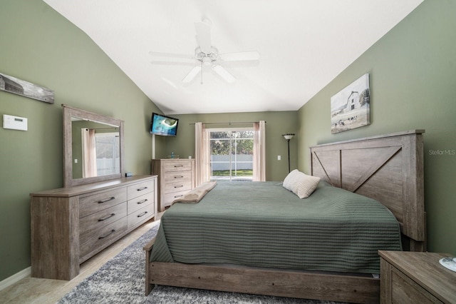 bedroom featuring access to exterior, vaulted ceiling, baseboards, and a ceiling fan